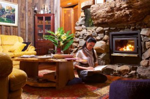Guest relaxing by raging fire at Tamborine Mountain Bed and Breakfast